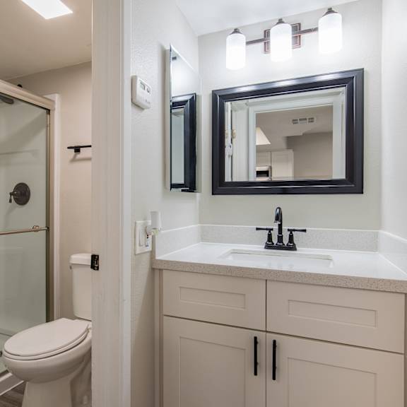 a bathroom with a sink toilet and shower