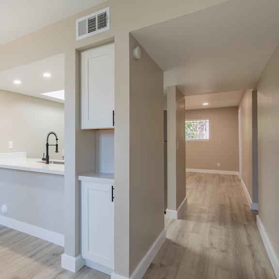 a kitchen with white cabinets and a white counter top