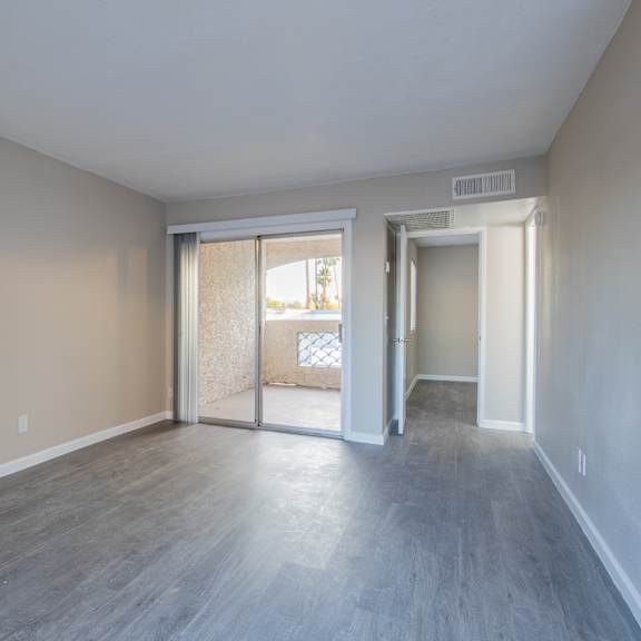 a bedroom with hardwood floors and beige walls  at sofia apartments, tempe, az