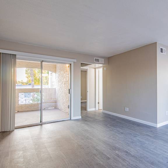 an empty living room with a sliding glass door to a patio  at sofia apartments, arizona at sofia apartments, tempe, 85283