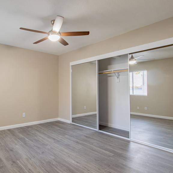 a bedroom with hardwood floors and a ceiling fan  at sofia apartments, arizona