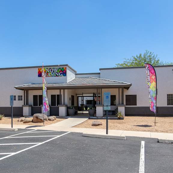 a white building with a colorful sign on the front of it