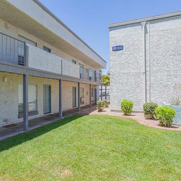 apartment building with a green lawn in front at sofia apartments, tempe, 85283