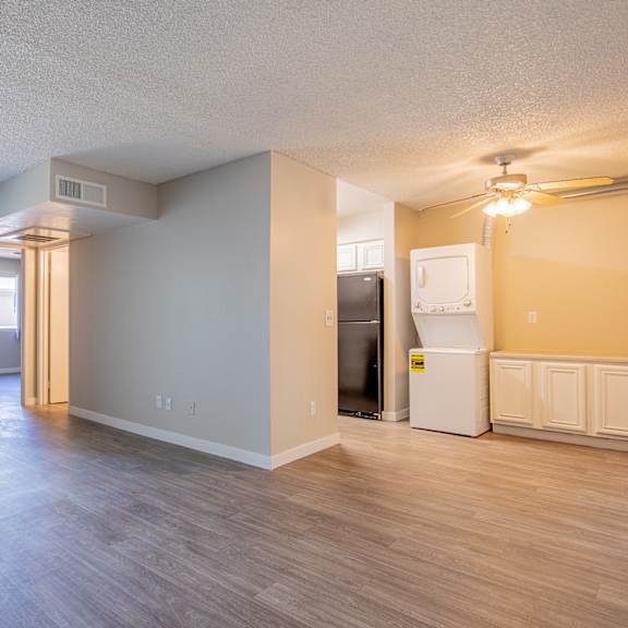 an open living room with a door leading to a balcony