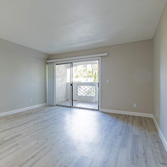 a room with a sliding glass door leading to a balcony at sofia apartments, tempe, 85283