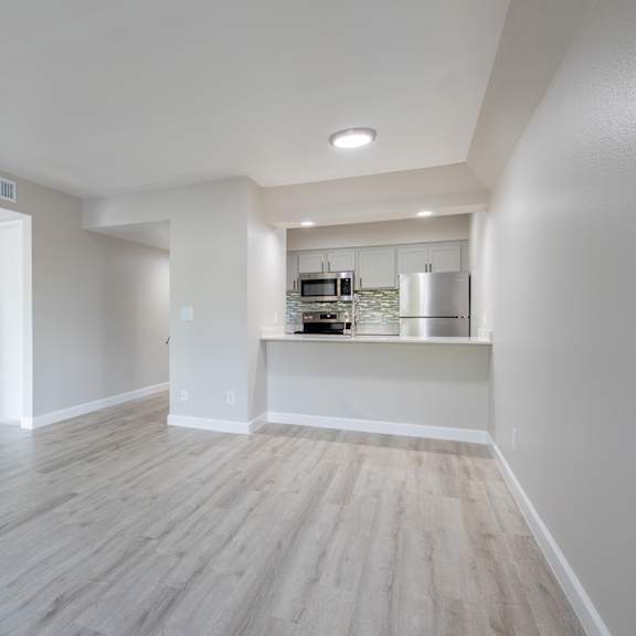 a kitchen area with a countertop and cabinets is visible through a doorway at sofia apartments, tempe, 85283