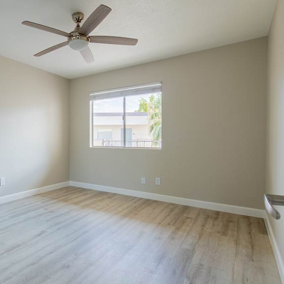 a room with a ceiling fan and a window at sofia apartments, tempe, 85283