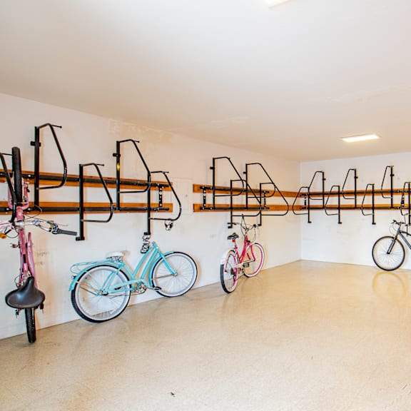 a room with several bikes hanging on a wall and a bike rack on the wall
