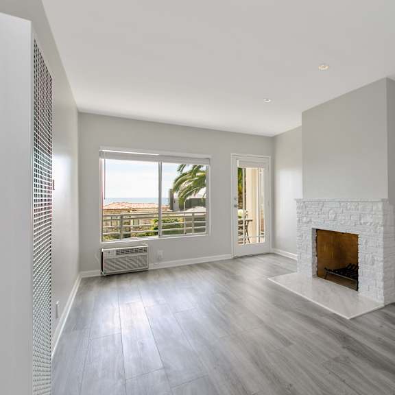 a living room with a fireplace and a window