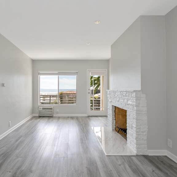 a living room with a fireplace and a window