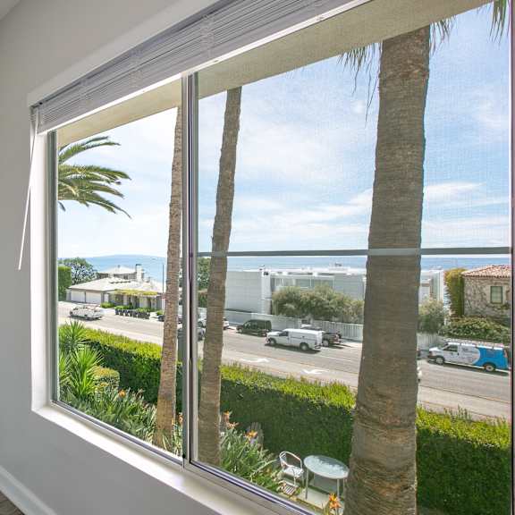 a view of the ocean from a window of a house