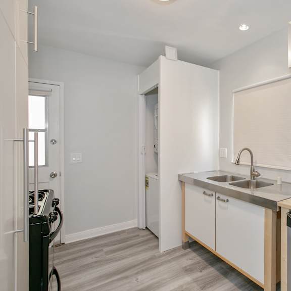 a kitchen with a sink and a dishwasher in a house