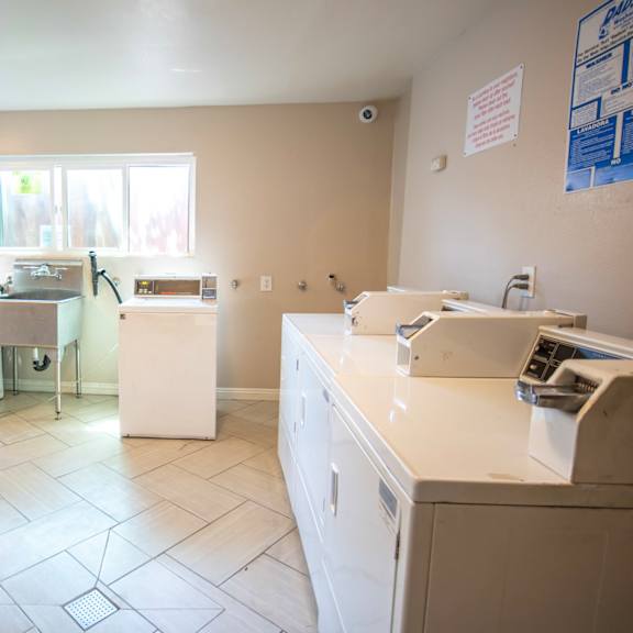 an empty kitchen with appliances and a window