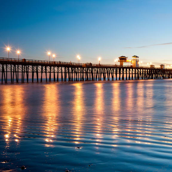 the pier at dusk at the beach