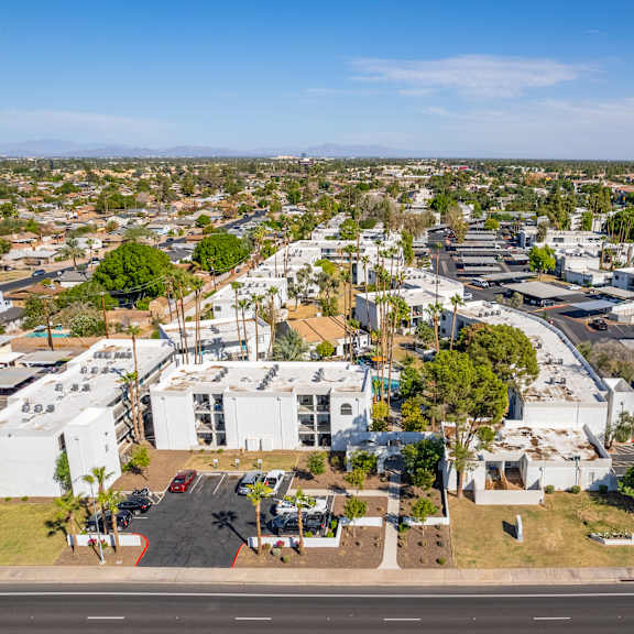 an aerial view of a city with white buildings and trees