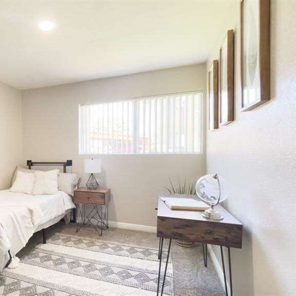 a bedroom with a bed and a window