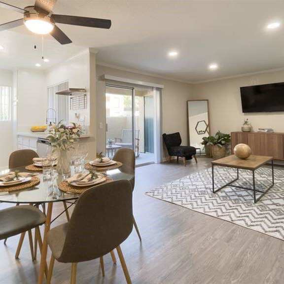 a dining room and living room with a table and chairs