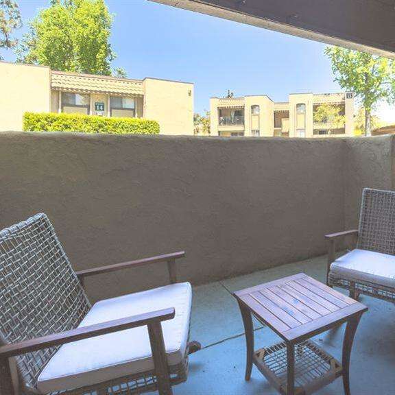 a patio with two chairs and a table