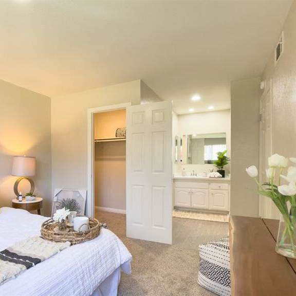 a bedroom with a large bed next to a bathroom