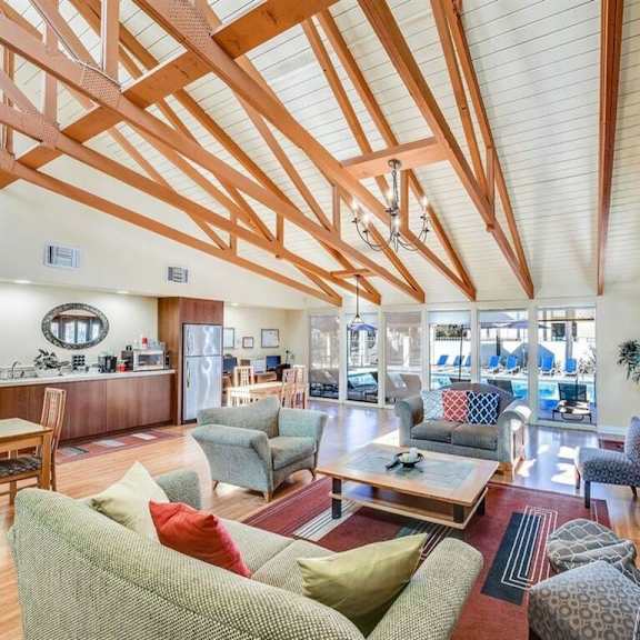 a living room with a fireplace and wooden beams on the ceiling