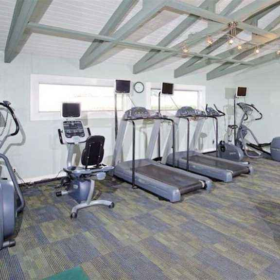 a room filled with lots of different types of exercise equipment