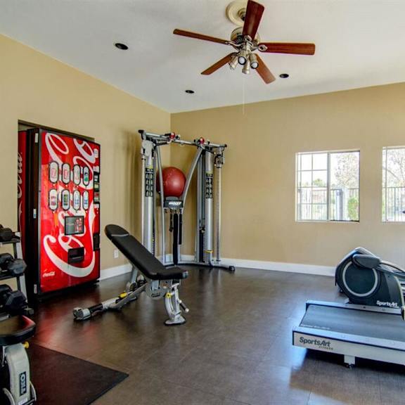 a home gym with a coke machine