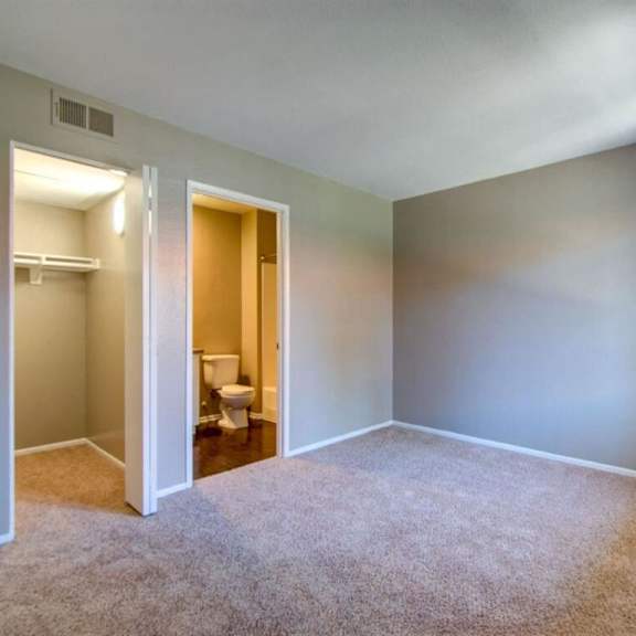 an empty room with a toilet and a closet