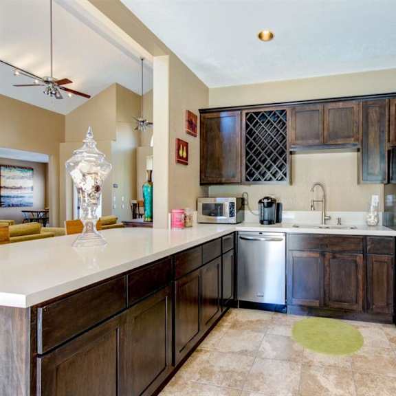 a kitchen with wooden cabinets and stainless steel appliances