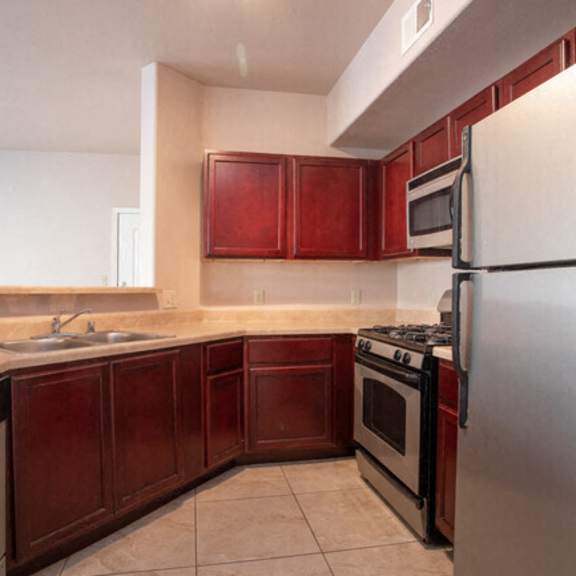 a kitchen with stainless steel appliances and wooden cabinets