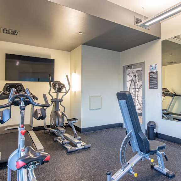 a gym with treadmills and other exercise equipment at the belgard apartments