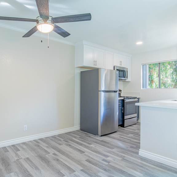 a kitchen with a refrigerator, microwave, and oven.