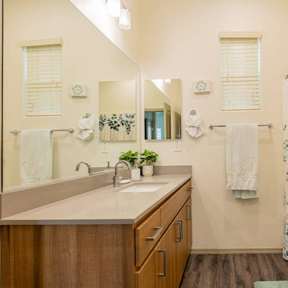 a bathroom with a shower and a sink and a mirror at villas on olive, peoria, arizona