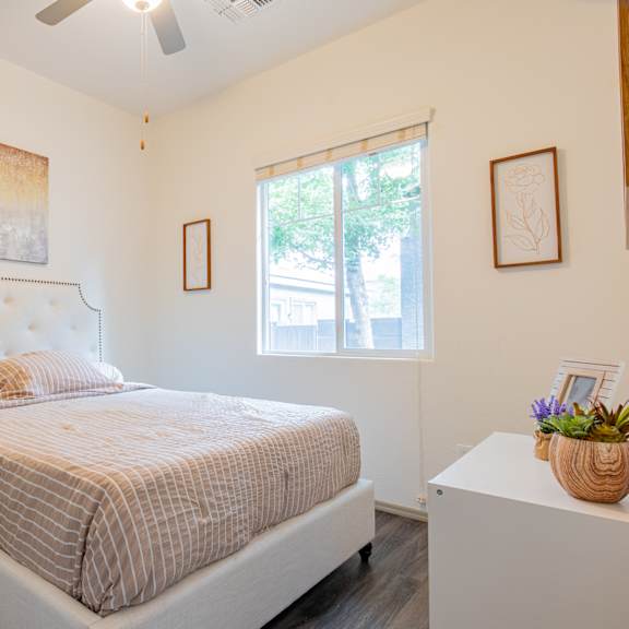a bedroom with a bed and a window at villas on olive, peoria, arizona