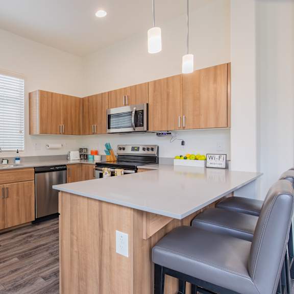 a kitchen with wooden cabinets and a white counter top at villas on olive, peoria, arizona