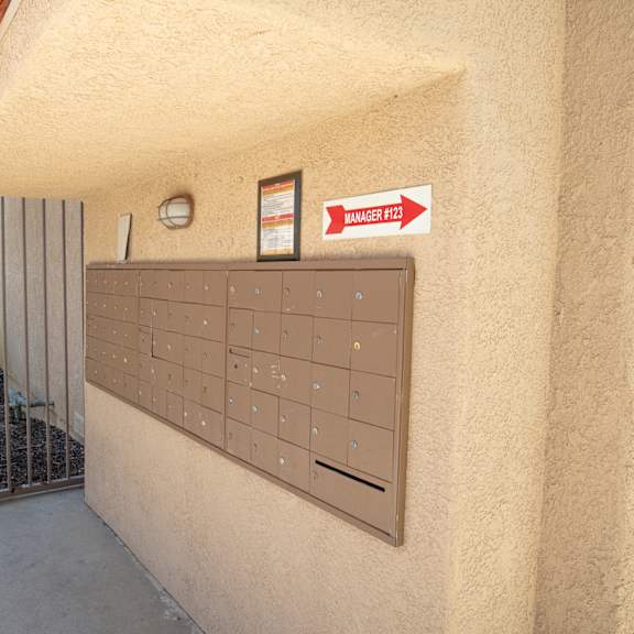 a garage door with a mailbox and a sign on the side