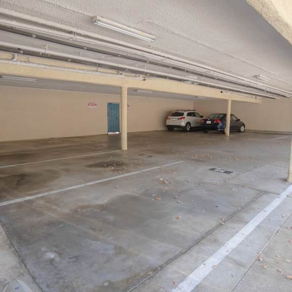 a parking garage with two cars in it