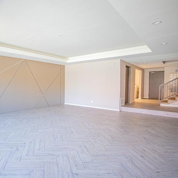 a large empty room with white walls and a wooden floor