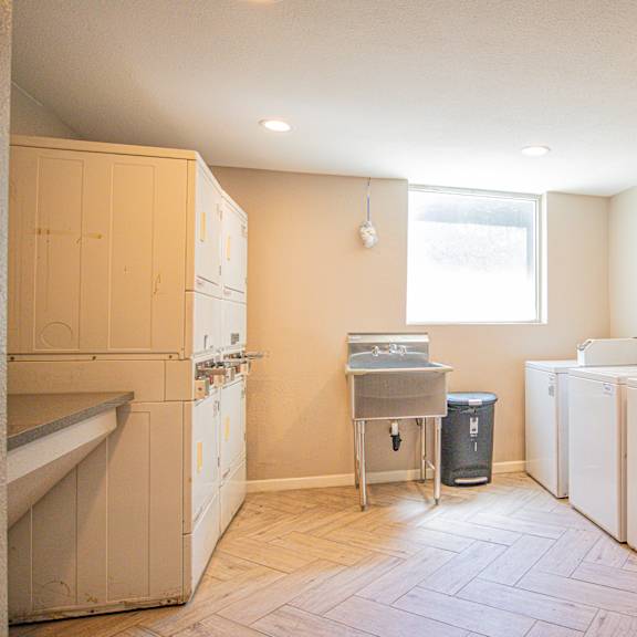 a kitchen with white appliances and a window.