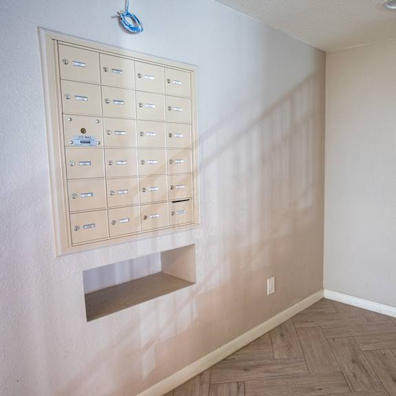 a wall with a mailbox and a mailbox holder.