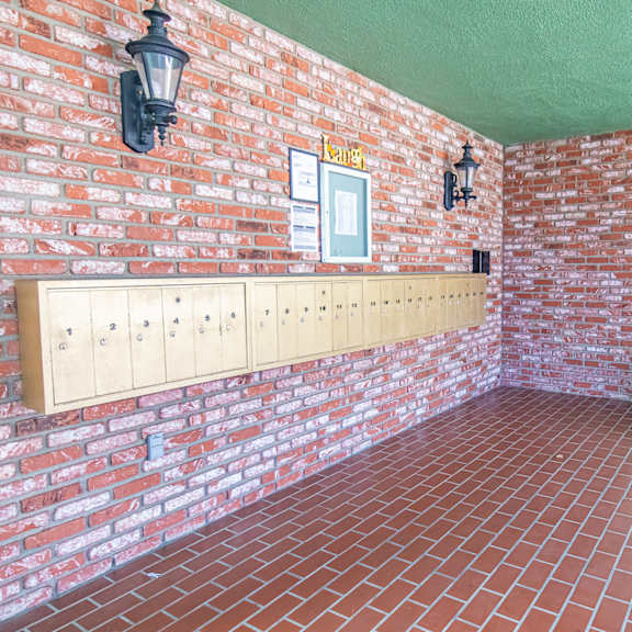a room with a brick wall and a plant