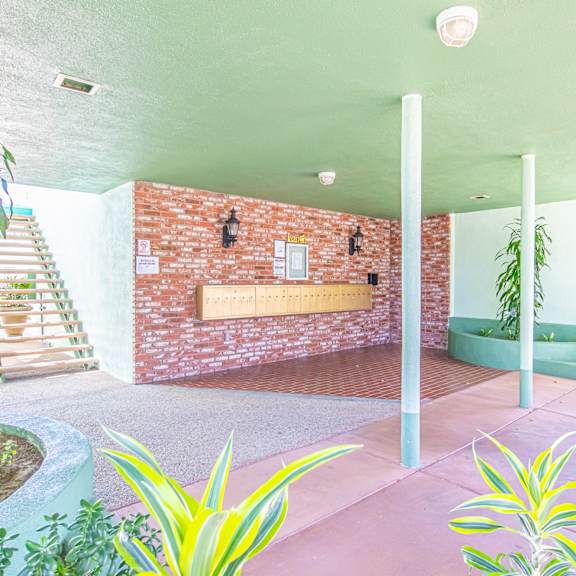 a bathroom with a brick wall and a green tub in the corner