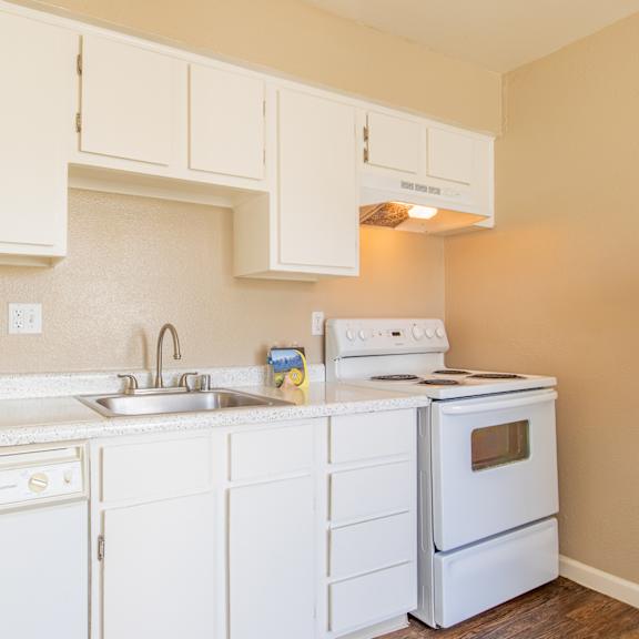 a kitchen with white appliances and white cabinets
