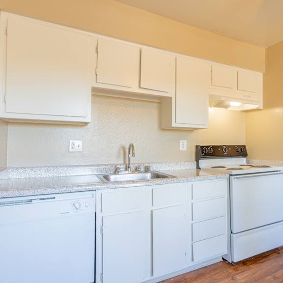 a kitchen with white appliances and white cabinets