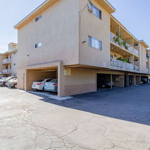 a building with a parking lot and cars in front of it