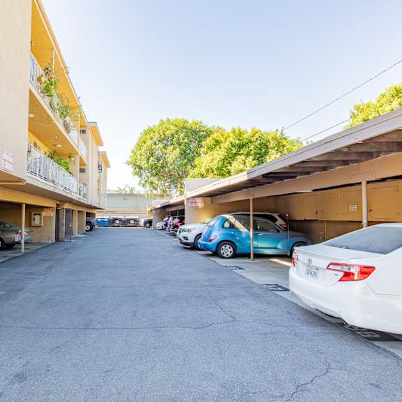 the view of a parking lot with cars parked next to a building