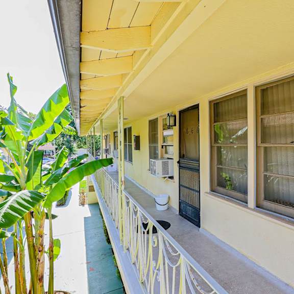 a building with windows and a balcony with a porch