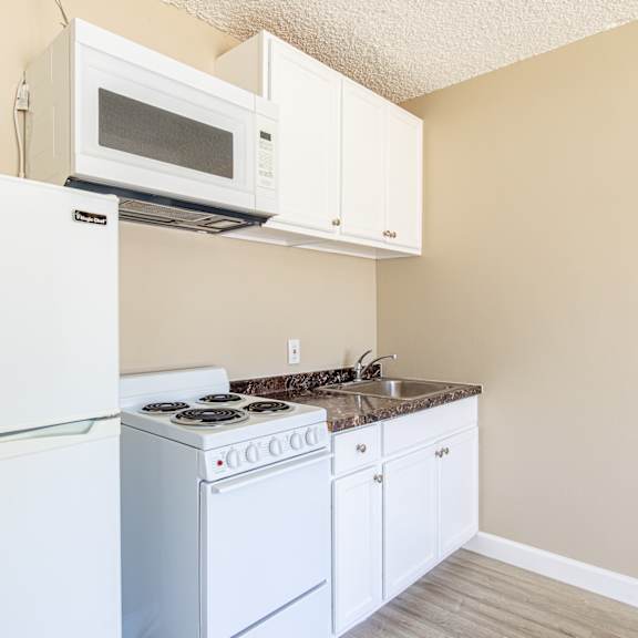 a kitchen with a stove microwave and refrigerator
