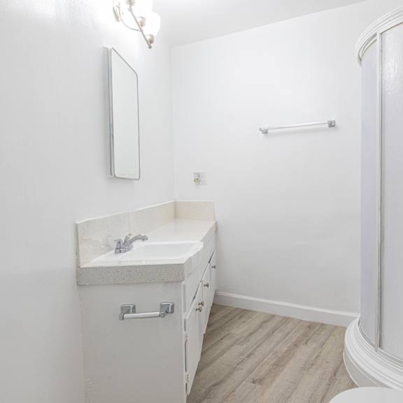 a bathroom with a shower and a sink and a toilet