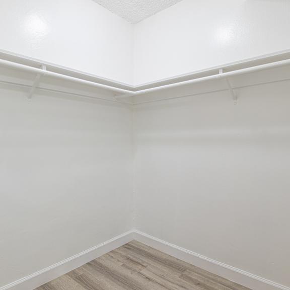 an empty room with white walls and a wooden floor