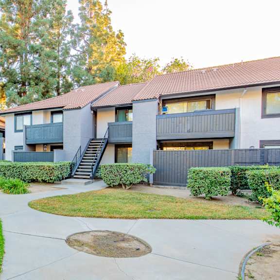 a group of apartment buildings with a yard and sidewalk at metro 3610, california